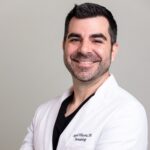 professional headshot of Dr. Miguel Villacorta smiling in a white coat