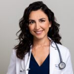a professional headshot of Dr. Stella Villacorta smiling in her doctor's coat