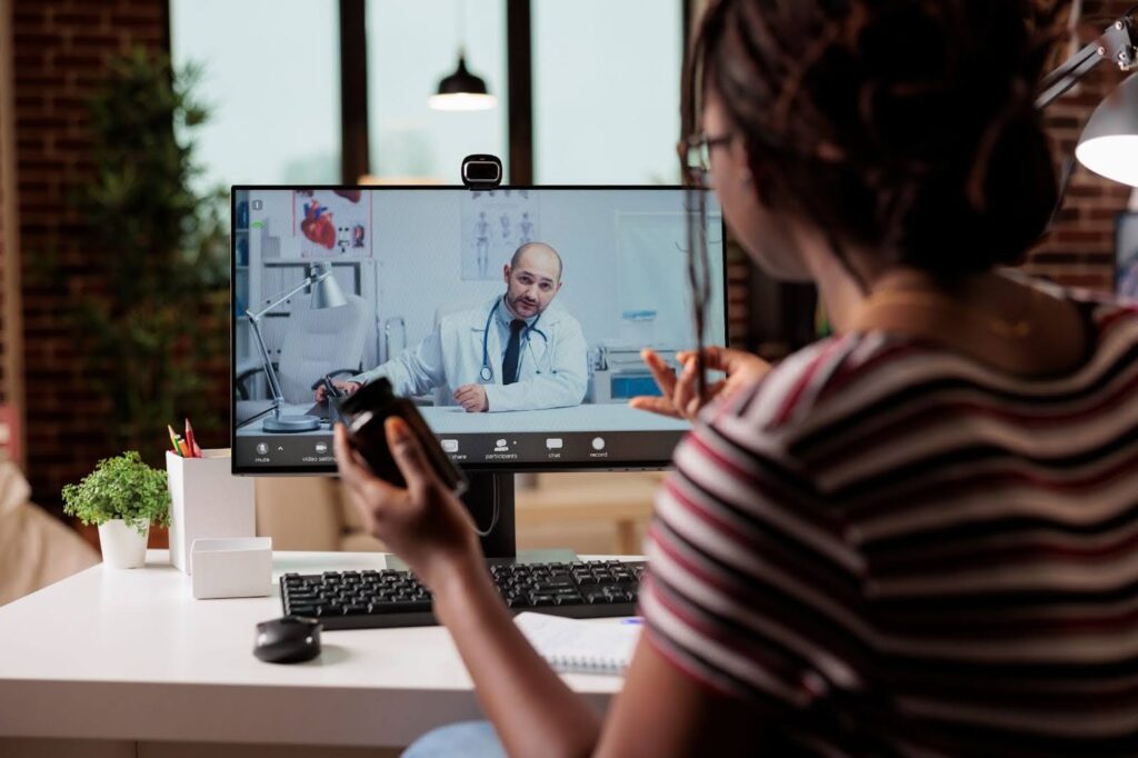 A patient user her computer to meet for an online doctor visit in Fort Lauderdale