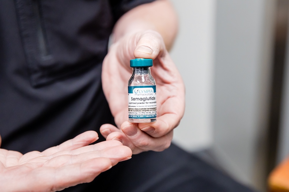 Provider holding a bottle of semaglutide, which is part of a comprehensive weight loss plan in Fort Lauderdale.