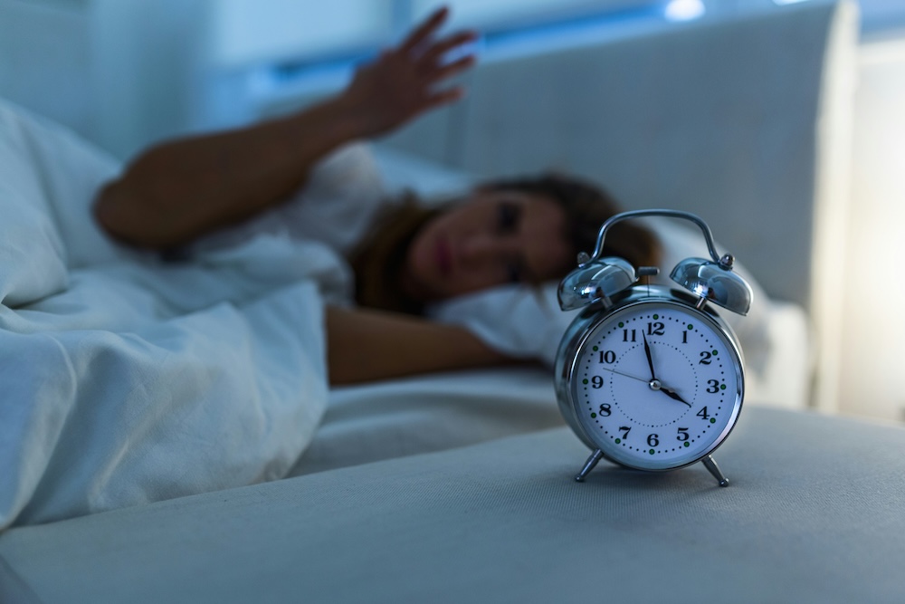 Woman having trouble sleeping and unsure what is causing her nightly disruptions. THis is one symptom that hormone replacement therapy for perimenopause in Fort Lauderdale can treat.